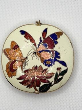 A vintage cloisonné enamel pendant with lotus and butterfly motifs.